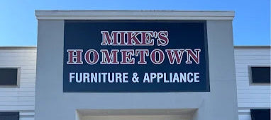 Storefront of Mike's Hometown Furniture & Appliance with a clear blue sky.